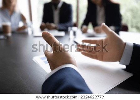 Close up shot of male businessman ceo boss proposing staff to share opinions on meeting, mentor or coach explaining training programme to group of interns, manager offering deal to diverse customers Royalty-Free Stock Photo #2324629779