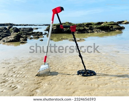 metal detector, sand scoop for metal detecting at beach - metal detector beach stock photo