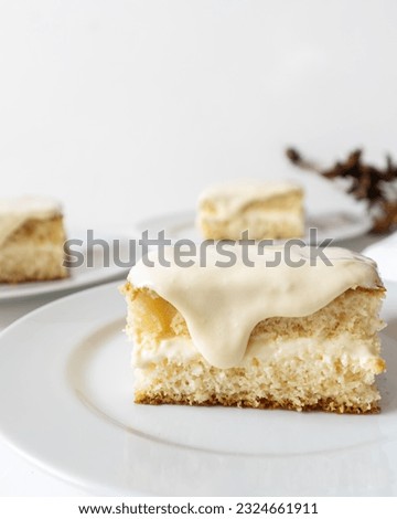 White chocolate cake filled with white chocolate ganache in white background