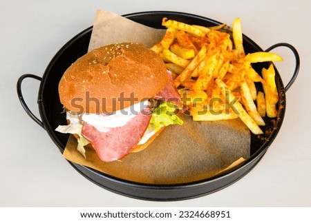 Big tasty burger with beef cutlet on a plate. Crispy chicken burger.