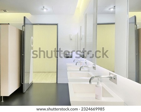 Hand basins in public restrooms There is liquid soap available. Royalty-Free Stock Photo #2324669985
