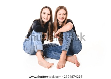 The Two Young pre teen best friend girl on studio white Royalty-Free Stock Photo #2324674293