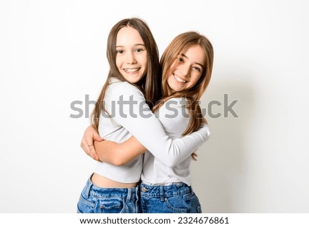 The Two Young pre teen best friend girl on studio white