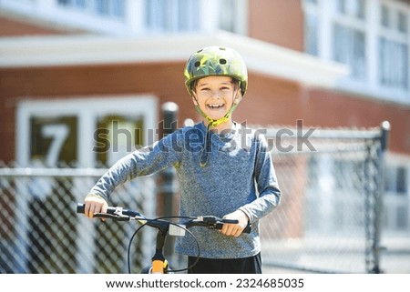 A child having fun outdoors driving bike for children on playground