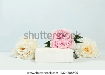 Abstract background with natural wooden podium and peonies flowers, empty showcase for display or presentation of cosmetic products, minimal flower arrangement, selective focus