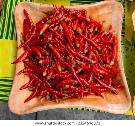 Wooden bowl full of hot red chili peppers