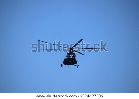 Helicopter flying in the sky in front of photo