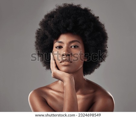 Skincare, black girl and makeup with confidence in portrait for wellness in studio background with afro. Beauty, face and glowing skin with african woman with cosmetics for dermatology with makeup. Royalty-Free Stock Photo #2324698549