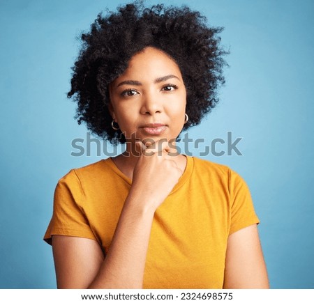 Portrait, serious and woman with a decision, focus and girl against a blue studio background. Face, female person or model with problem solving, solution or fantasy with future, assertive or question