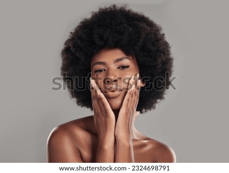 Portrait, african and woman is feeling with glowing skin in studio background for wellness with afro. African, woman and makeup with dermatology or beauty with facial treatment for self care. Royalty-Free Stock Photo #2324698791