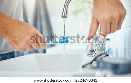 Hands, toothbrush and person at tap for water, dental hygiene and gum care at home. Closeup, brushing teeth and rinse oral product for fresh grooming, morning routine and cleaning at bathroom sink Royalty-Free Stock Photo #2324698841