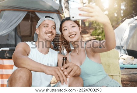 Selfie, love and young couple on a camp in the woods for a summer weekend trip or holiday. Happy, smile and man with beer while his girlfriend taking a picture in forest on outdoor vacation together.