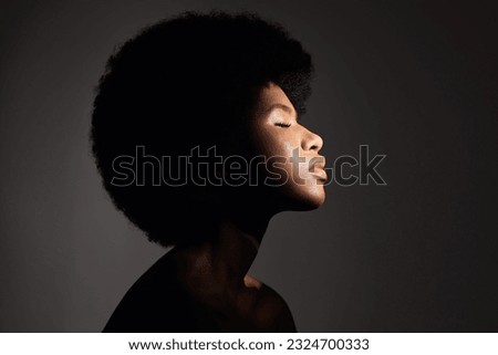 Face shadow, light and black woman with skincare, natural beauty glow and peace after cosmetics treatment. Aesthetic makeup profile, afro and African studio person with self care on grey background
