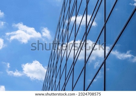 Reflection of the sky and clouds in the tinted windows of the building