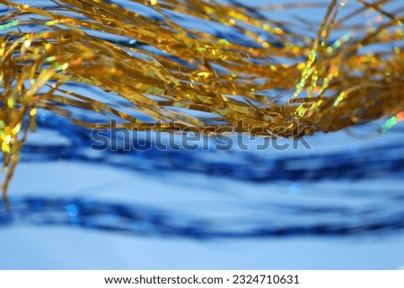 Yellow and blue stripes on blue sparkle in the wind.