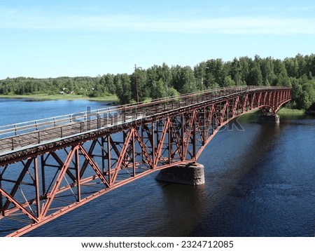 Red truss steel bridge crossing river lake Vuoksa  Royalty-Free Stock Photo #2324712085