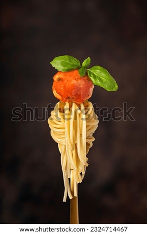 Macro food photography of meatball, chicken, beef; meat, spaghetti, pasta, tomato, sauce, basil, veal, fried, grilled, roasted, fork Royalty-Free Stock Photo #2324714467