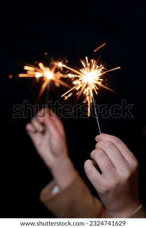 hand holding flame in dark background