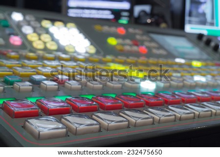 Wide shot of vision mixing panel in a television gallery.