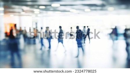 Walking Blurred People in a Bright Large Hall