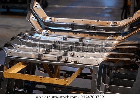 Details of car carcass hang on assembling conveyor Royalty-Free Stock Photo #2324780739