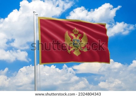 Montenegro national flag waving in the wind on clouds sky. High quality fabric. International relations concept