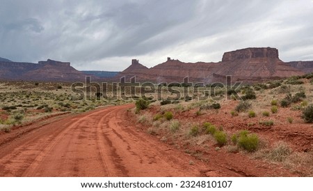 Red dirt road with a mountain in the background. Arches national park, Utah, USA