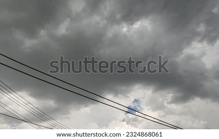 The sky when the rain is coming and the power lines are missed