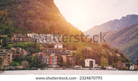italian village on the lake with alps background. View of village on Como Lake, Milan, Italy with Alps mountains in background.