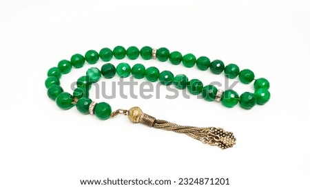 Green agate stone prayer beads tasbih on a white background  Royalty-Free Stock Photo #2324871201