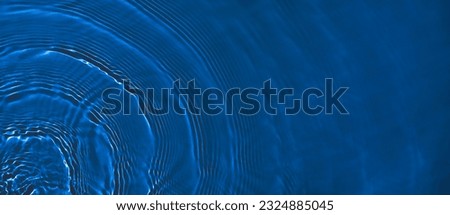 Transparent dark blue clear water surface texture with ripples and splashes. Abstract summer banner background Water waves in sunlight with copy space Cosmetic moisturizer micellar toner emulsion Royalty-Free Stock Photo #2324885045