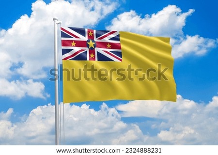 Niue national flag waving in the wind on clouds sky. High quality fabric. International relations concept