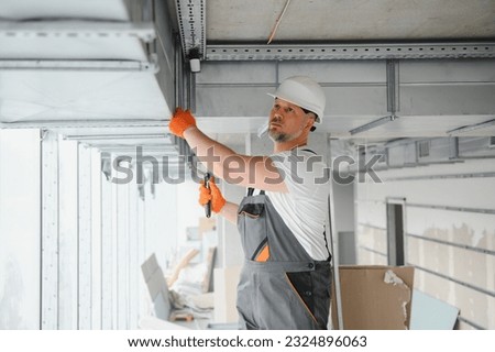 hvac services - worker install ducted pipe system for ventilation and air conditioning in office Royalty-Free Stock Photo #2324896063