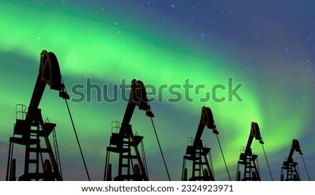 Oil pump jack under the blue sky with aurora borealis