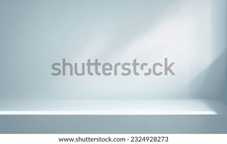 Minimal abstract light blue background for product presentation. Shadow and light from windows on plaster wall. Royalty-Free Stock Photo #2324928273