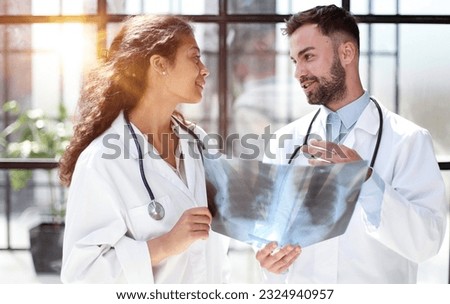 Two busy doctors working with papers and xray images