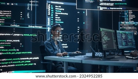 Portrait of Woman Working on Computer, Typing Lines of Code that Appear on Big Screens Surrounding her in Dark Monitoring Room. Female Programmer Creating Innovative Software Using AI Data and System Royalty-Free Stock Photo #2324952285