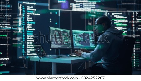Black Male Developer Typing on Computer, Surrounded by Transparent Screens Showing Code Prompts. Professional Programmer Creating Complex Software, Running Coding Tests. Futuristic Programming Concept Royalty-Free Stock Photo #2324952287