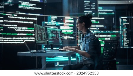 Portrait of Woman Working on Computer, Typing Lines of Code that Appear on Big Screens Surrounding her in a Monitoring Room. Female Programmer Creating Innovative Software Using AI Data and System