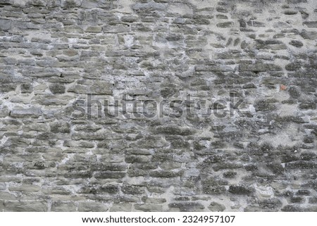 beautiful vintage texture of grey wall of medieval castle built in middle of 14th century, part of ancient building, monastery, temple, handmade, volumetric stones for designer, wallpaper, background