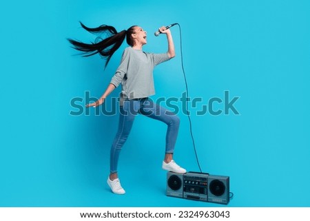 Full body photo of happy cheerful woman boombox music lover sing mic pop star isolated on blue color background.
