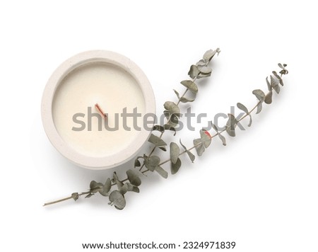 Holder with candle and eucalyptus on white background Royalty-Free Stock Photo #2324971839