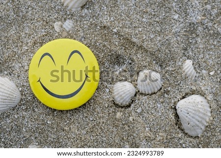 Yellow happy face with smile on nature background.