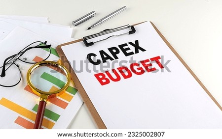 CAPEX BUDGET text on a clipboard with chart on white background, business concept