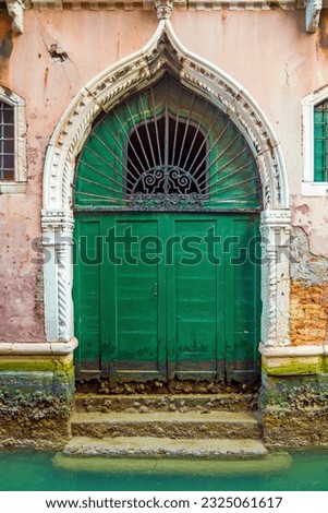 Old green door in vintage style in Venice, Italy
