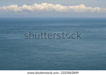 Coastal town of Ilfracombe, Devon, UK. Distant view of the Atlantic Ocean where some boats are floating.