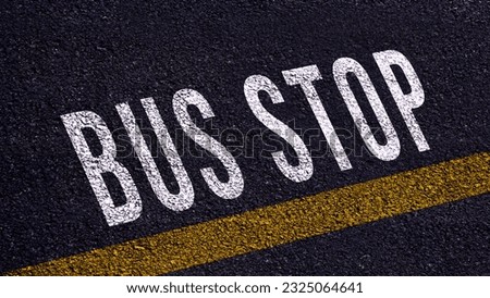 Bus stop text written and yellow line on the road in middle of the asphalt road, Bus stop word on street.