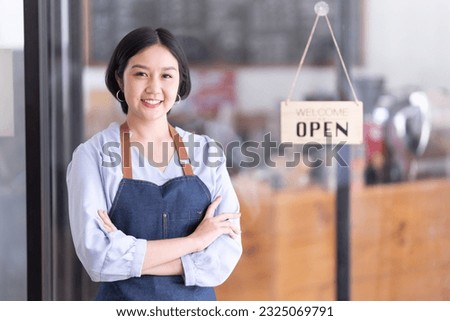 Startup successful small business owner sme beauty girl stand with tablet smartphone in coffee shop restaurant. Portrait of asian tan woman barista cafe owner. SME entrepreneur seller business concept Royalty-Free Stock Photo #2325069791