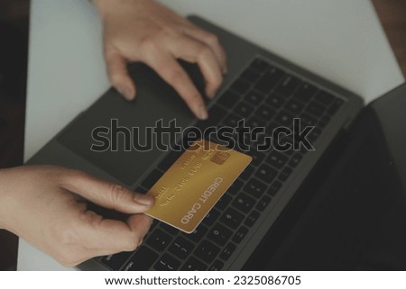Woman hands holding and using cradit card for shopping online.