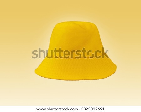 yellow bucket hat isolated on light yellow background